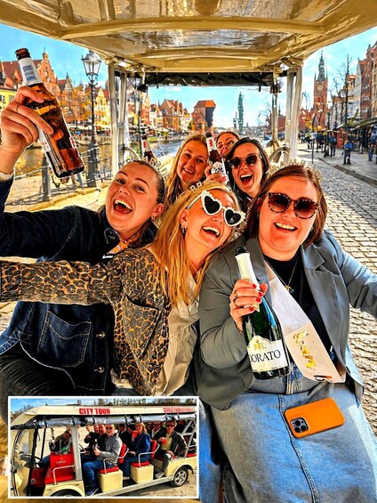 A group of people on a city tour, holding drinks and taking a selfie. 1