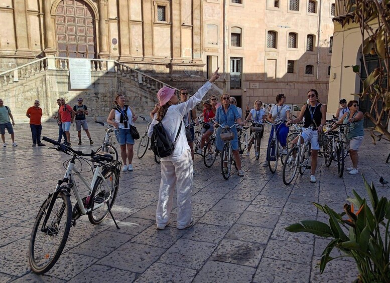 A group of people on bicycles in an urban setting with historic architecture. 5
