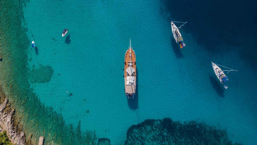Une mer turquoise et limpide où plusieurs bateaux sont amarrés. 2