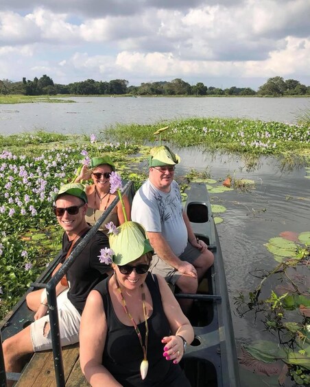 A group of people in a boat on a lake surrounded by water lilies. 4