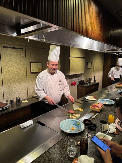 A chef preparing food on a grill in a modern kitchen. 4