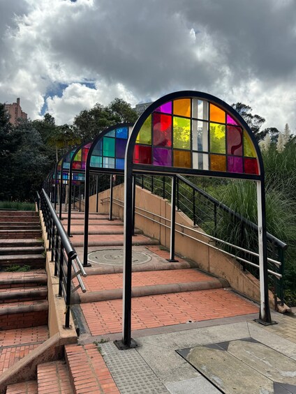 A staircase with colorful glass panels and metal railings. 4
