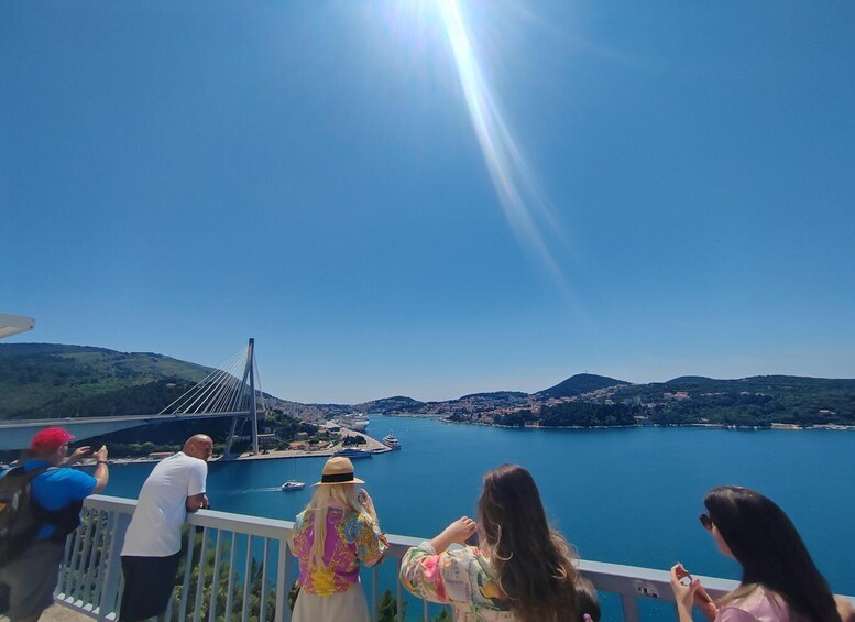 A bridge over a body of water with people observing. 5