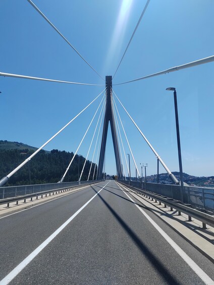 A bridge with multiple cables and a clear sky. 2