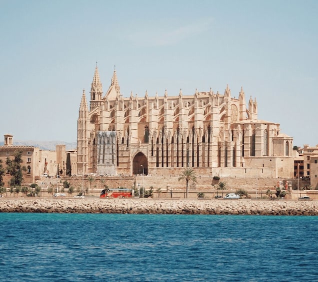 A large, ornate cathedral with multiple spires and a prominent entrance, situated by a body of water. 5