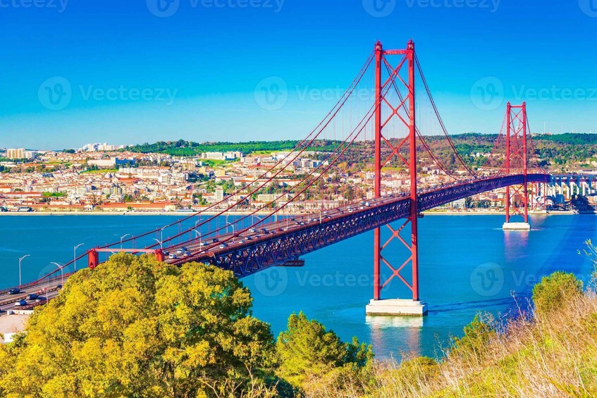 A red bridge spanning a river with a cityscape in the background. 5