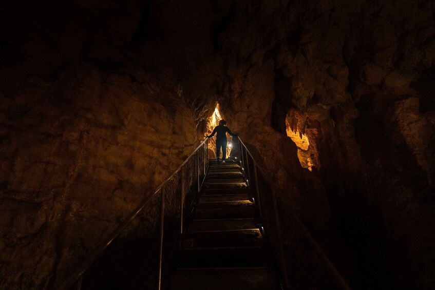 A staircase leading up to a fire in a cave. 4