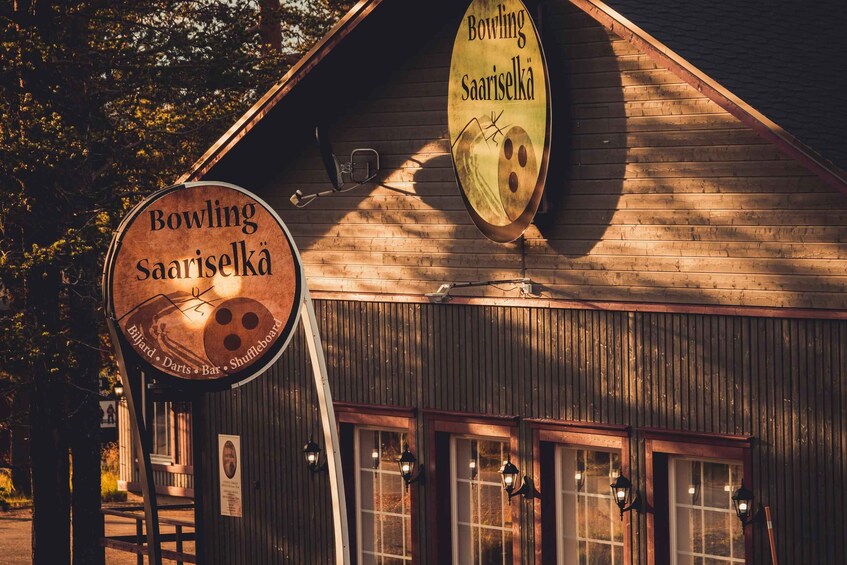 A wooden building with signs for 'Bowling Saariselka' and 'Billiard Darts Bar Shuffleboard'. 2