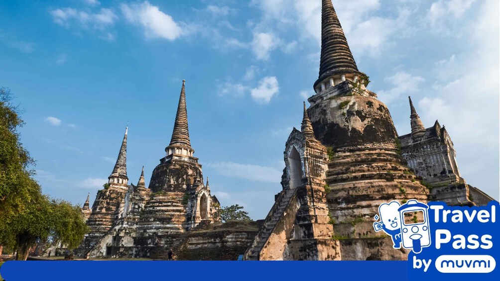 Ancient temple ruins with multiple tiered spires under a clear blue sky. 2