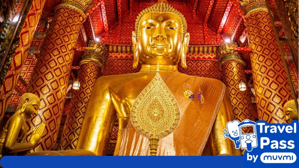 A large golden Buddha statue with intricate patterns and a red and gold patterned background. 5