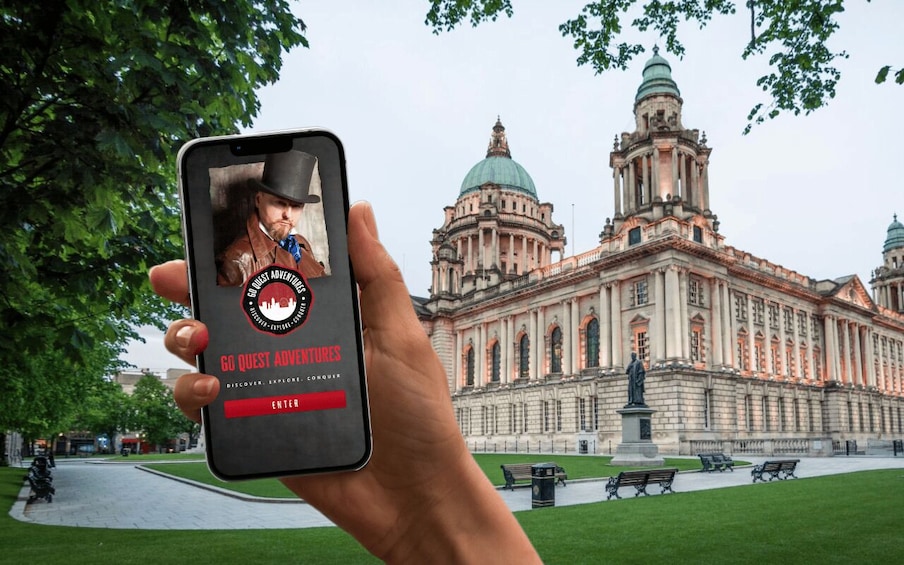 A person holding a smartphone with a game interface in front of a large historic building. 1