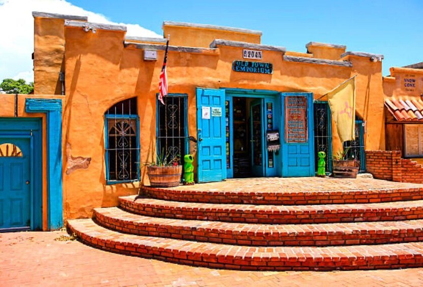 A building with blue doors and a sign reading "Old Town Emporium." 1