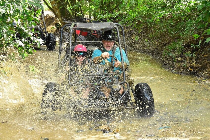 A vehicle driving through a muddy water crossing. 2