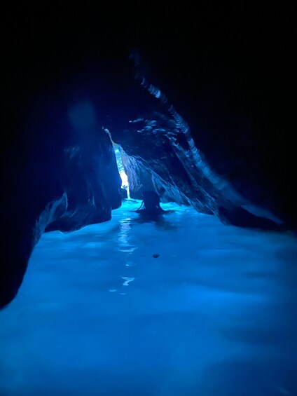 An ice cave with blue lighting and a frozen floor. 5
