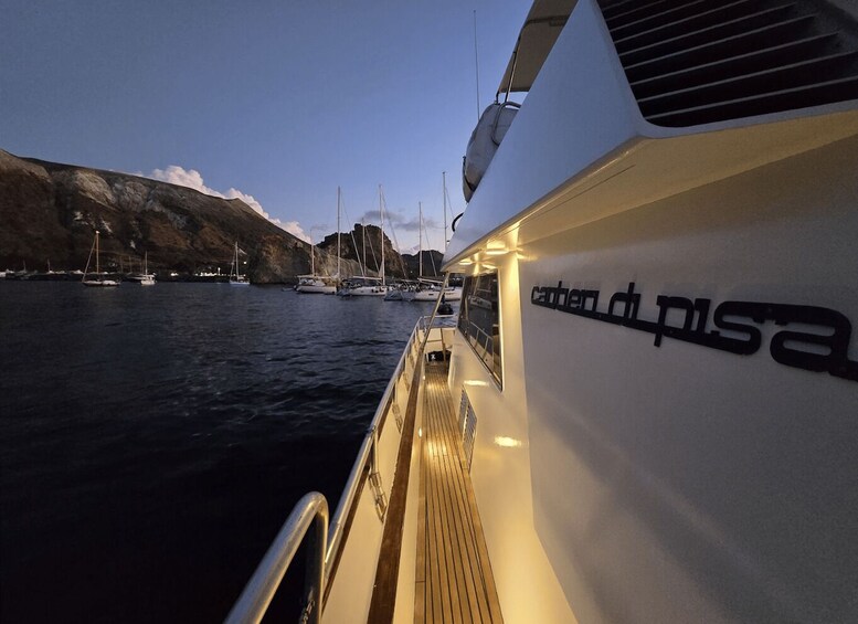 A boat docked at a marina with other boats in the background. 5