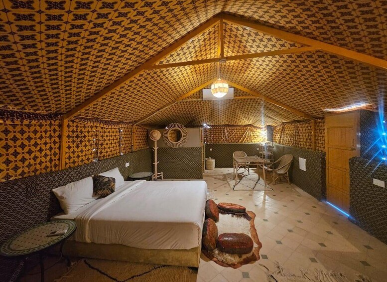 A cozy, tent-like room with patterned walls and a bed. 4