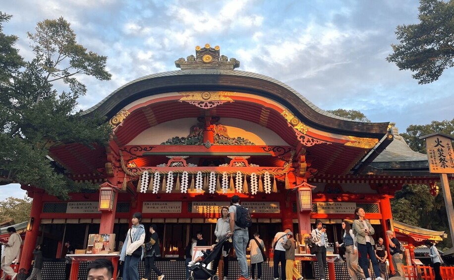 A traditional Japanese temple with ornate architecture and a red and gold color scheme. 3
