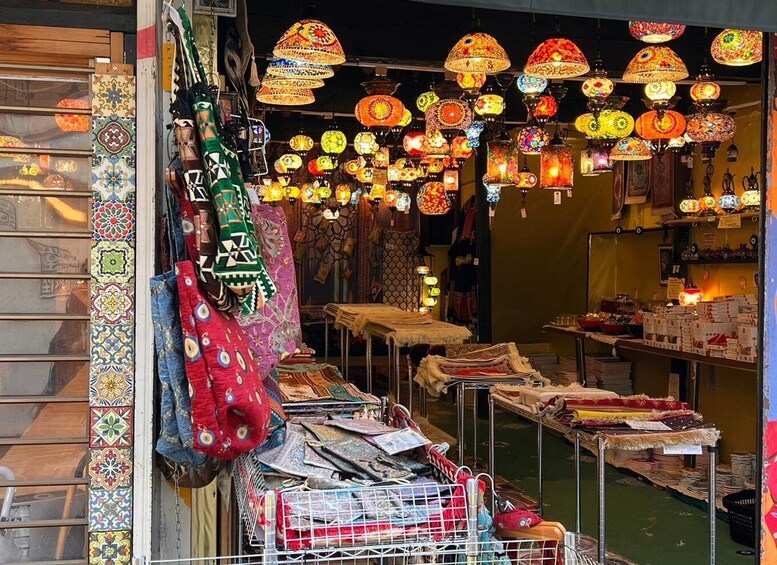 A vibrant market with colorful lanterns, textiles, and rugs. 3