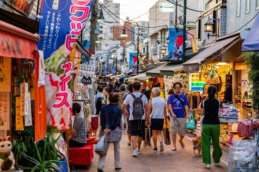 A crowded street with people walking, shops, and signs in a foreign language. 5