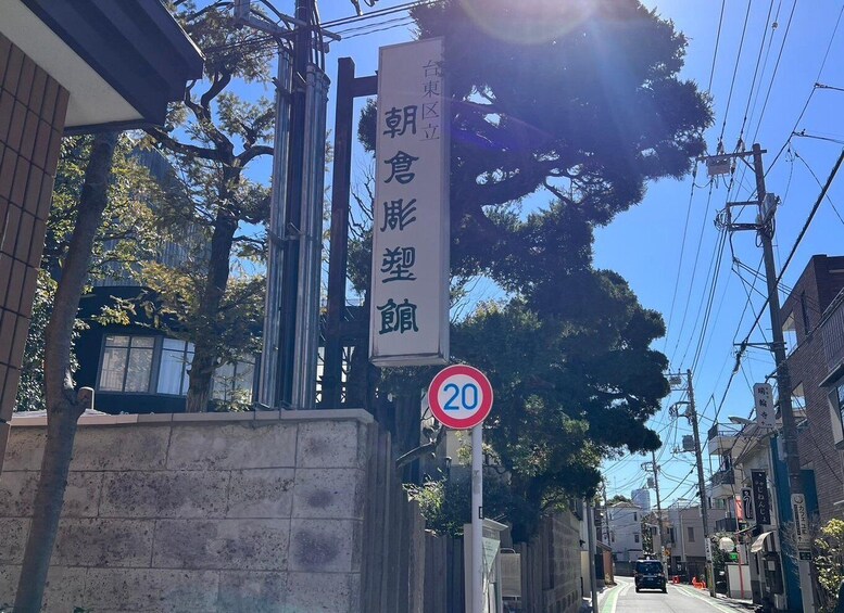 A street with a speed limit sign and a sign with Japanese characters. 4