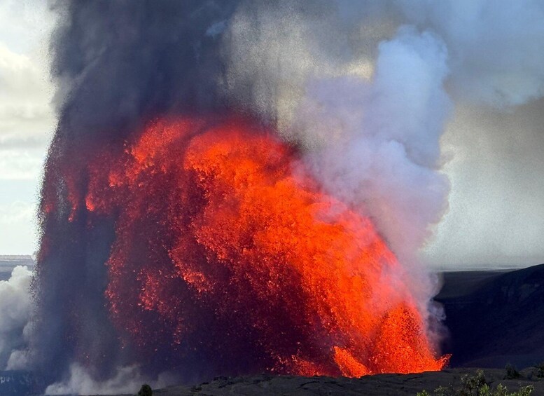 A large volcanic eruption with bright orange lava flowing and thick smoke. 5