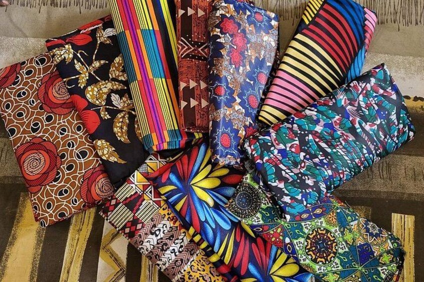 A collection of colorful, patterned fabrics laid out on a surface. 2
