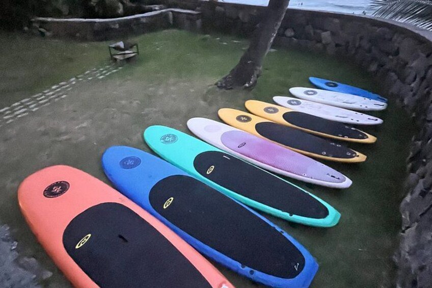 A row of colorful electric scooters lined up on a green surface. 1