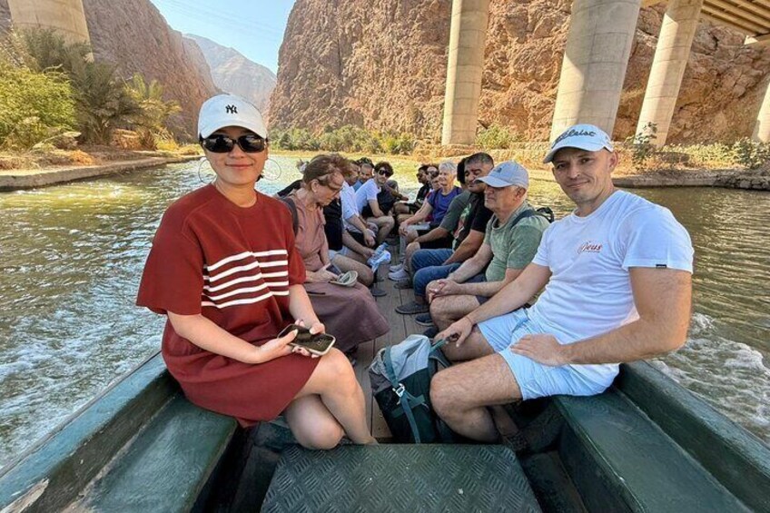 A group of people on a boat under a bridge. 1