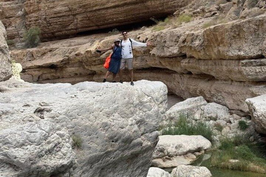 A rocky terrain with large boulders and a narrow passage. 3