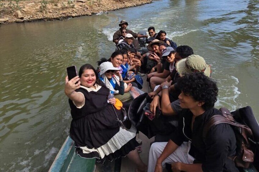 A group of people on a boat in a river. 2