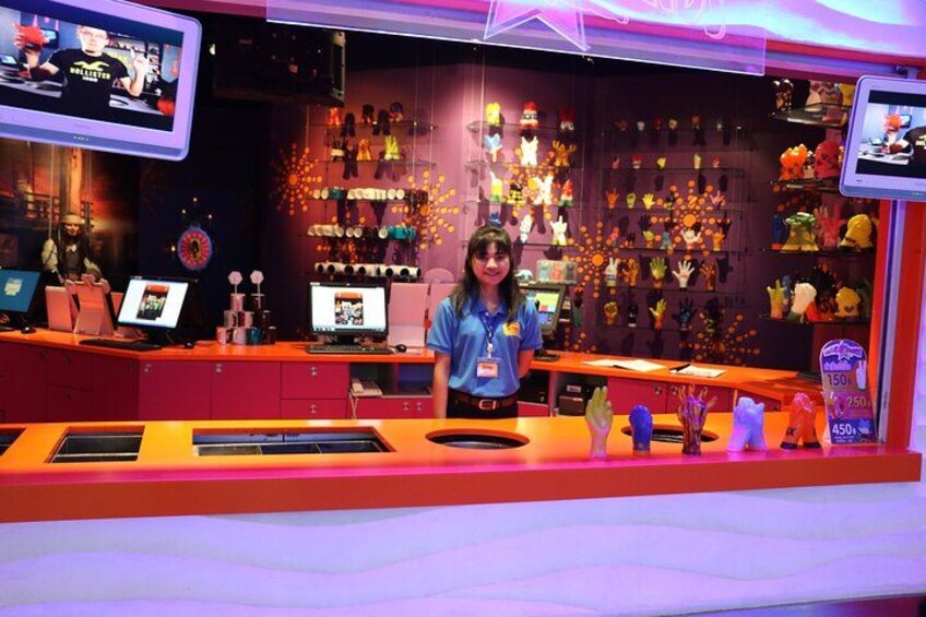 A brightly lit store with a counter, shelves of plush toys, and a TV screen. 4