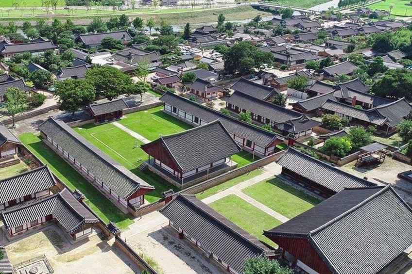 A traditional Korean village with wooden buildings and a central courtyard. 4