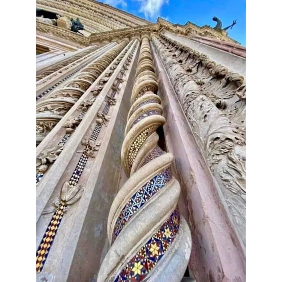 A close-up of a column with intricate carvings and colorful tile patterns. 2