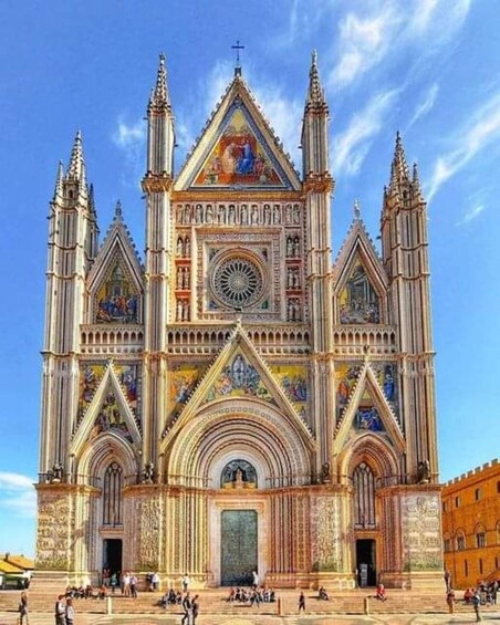 A large cathedral with intricate Gothic architecture, a prominent clock, and detailed stained glass windows. 3
