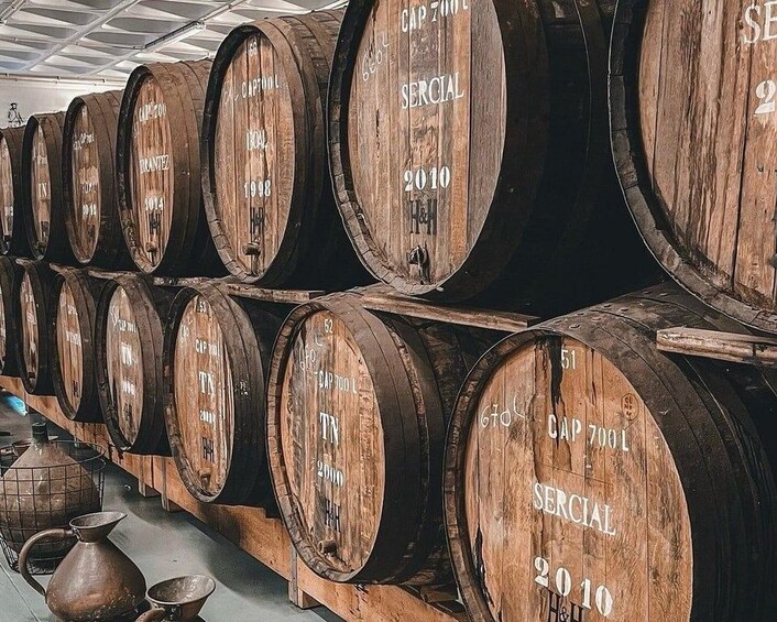 Wooden barrels stacked in a warehouse. 4