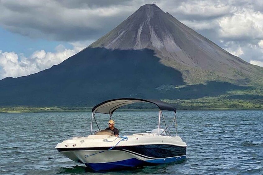A boat on calm water with a mountain in the background. 2