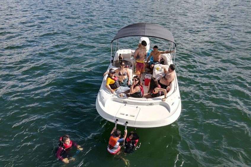 A small boat with people on it, floating on water. 4