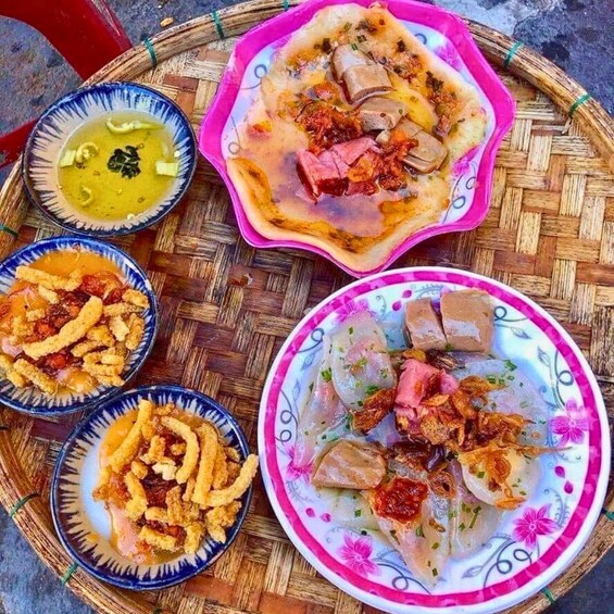 A variety of dishes including a bowl of soup, a plate with meat and vegetables, and a plate with fried items. 2