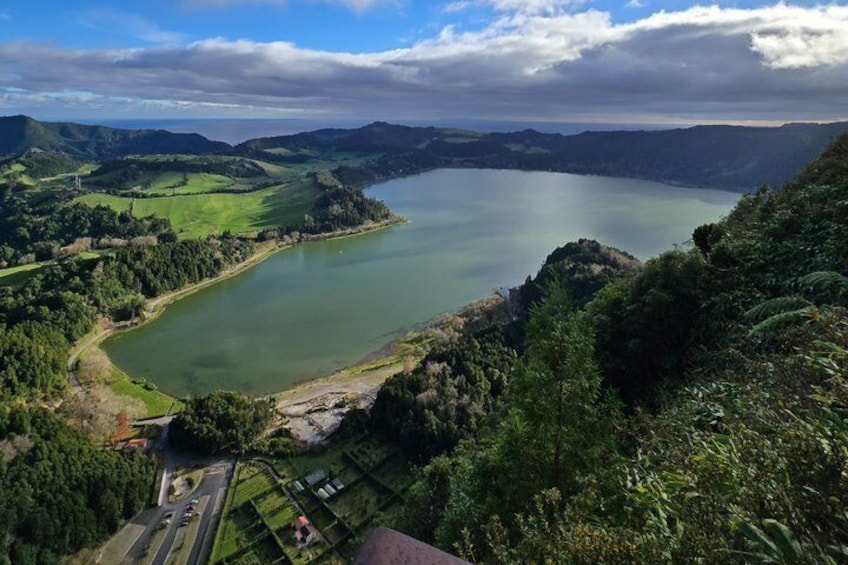 A lake surrounded by hills and greenery. 1