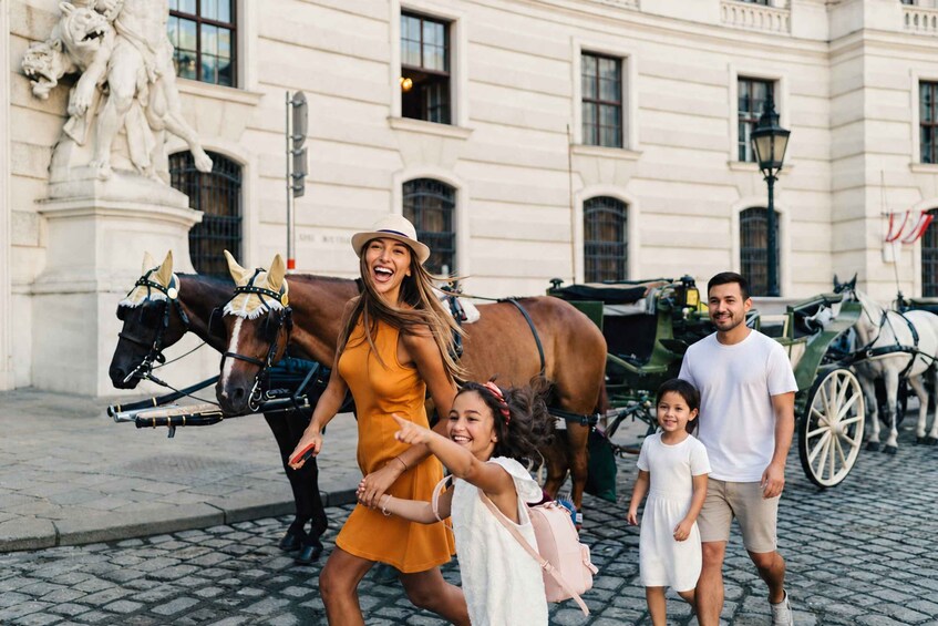 A family with a horse-drawn carriage in front of a historic building with statues. 4