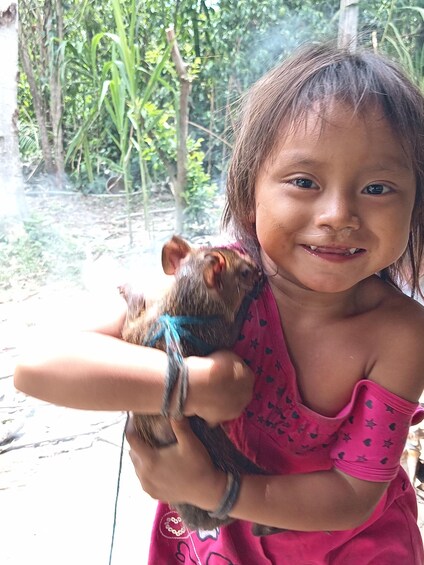 A child holding a monkey. 2