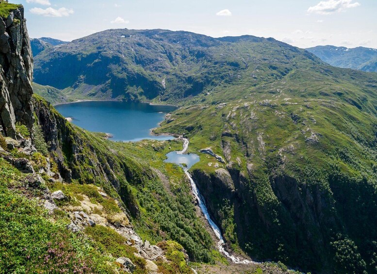 A mountainous landscape with a lake, a waterfall, and a river. 2