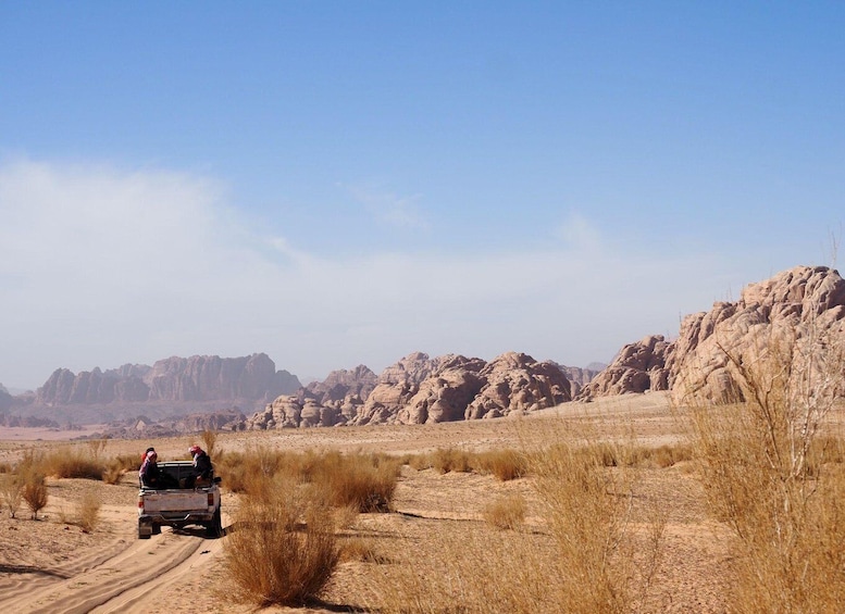A desert landscape with rocky hills and sparse vegetation. 5