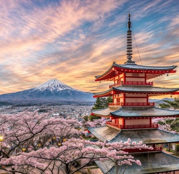 A traditional Japanese pagoda with cherry blossoms in the foreground and Mount Fuji in the background. 1