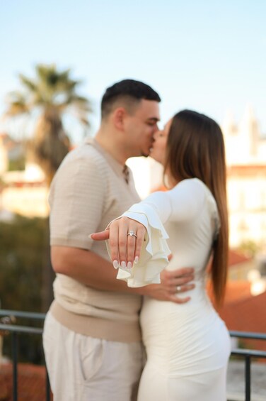A couple embracing with a blurred background of palm trees and buildings. 5