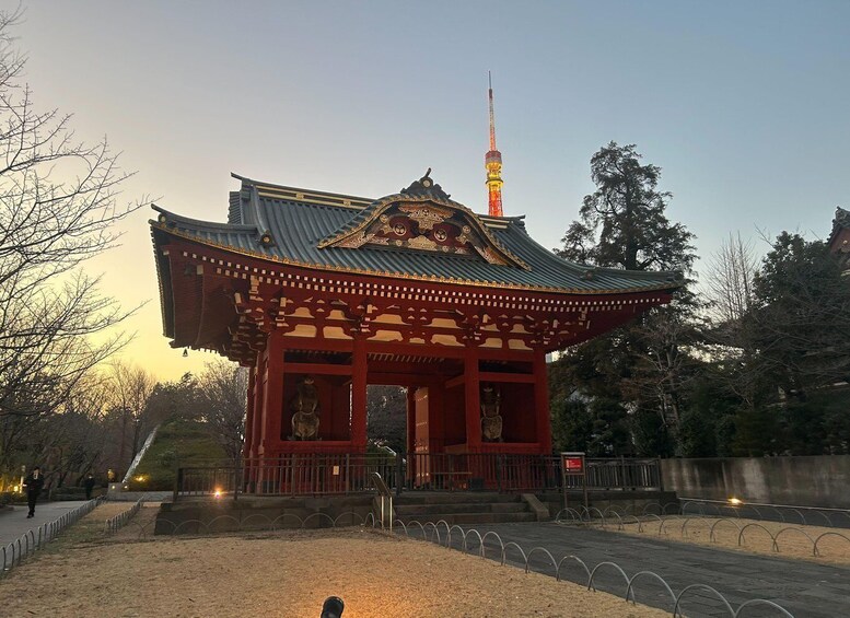 A traditional Japanese temple with a red roof, a pagoda in the background, and a tower with colorful lights. 2