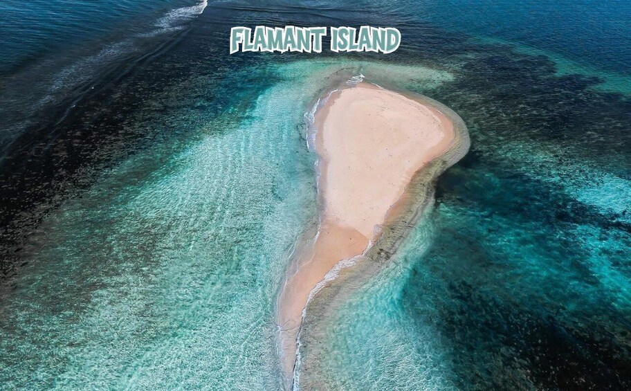 An aerial view of Flamant Island with clear turquoise waters and a sandy beach. 5