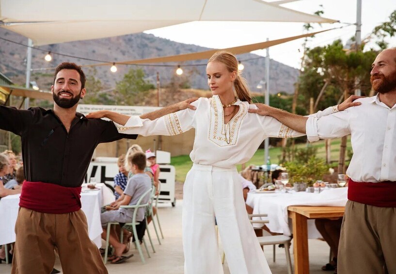 A group of people dancing outdoors at a social event. 1