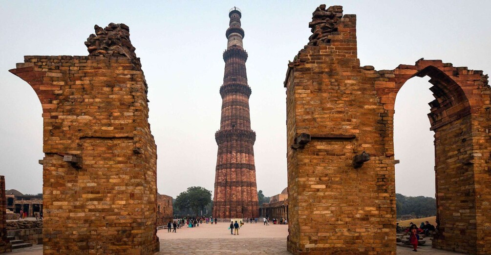 The Qutub Minar, an ancient minaret in Delhi, India, with its distinctive spiral design and brick construction. 4