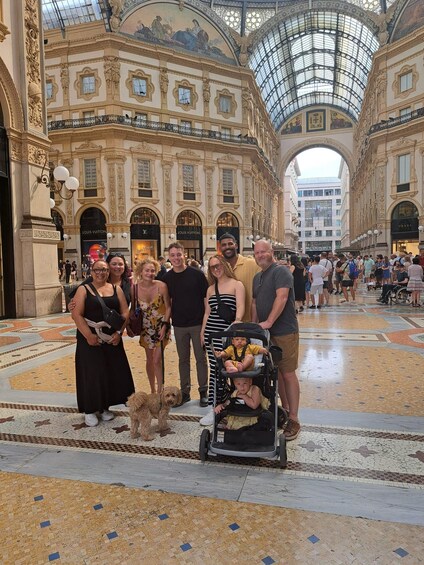 A group of people in a grand, ornate building with a glass ceiling and intricate architectural details. 1